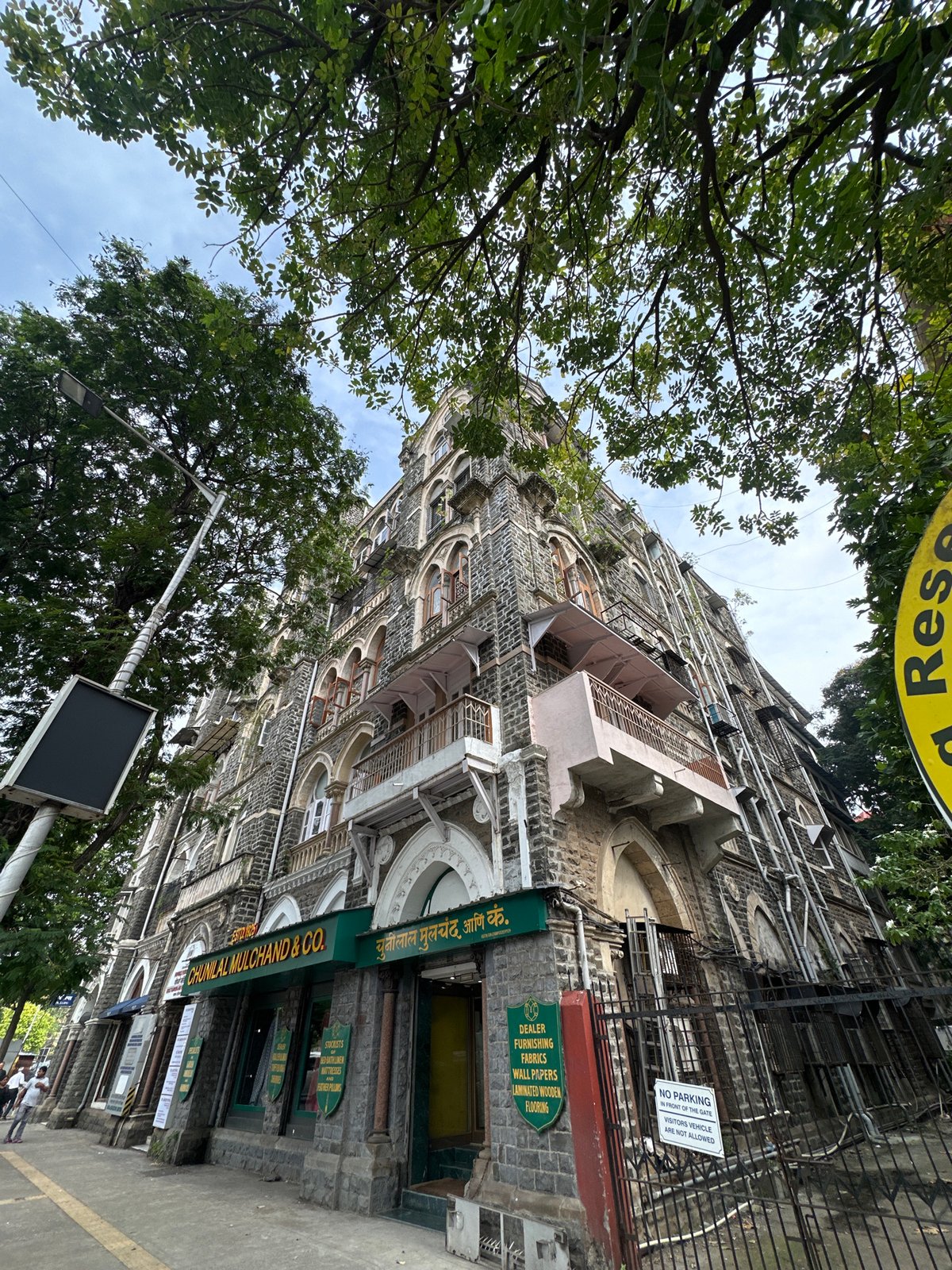 Historic stone commercial building with Chunilal Mulchand & Co. signage, Mumbai
