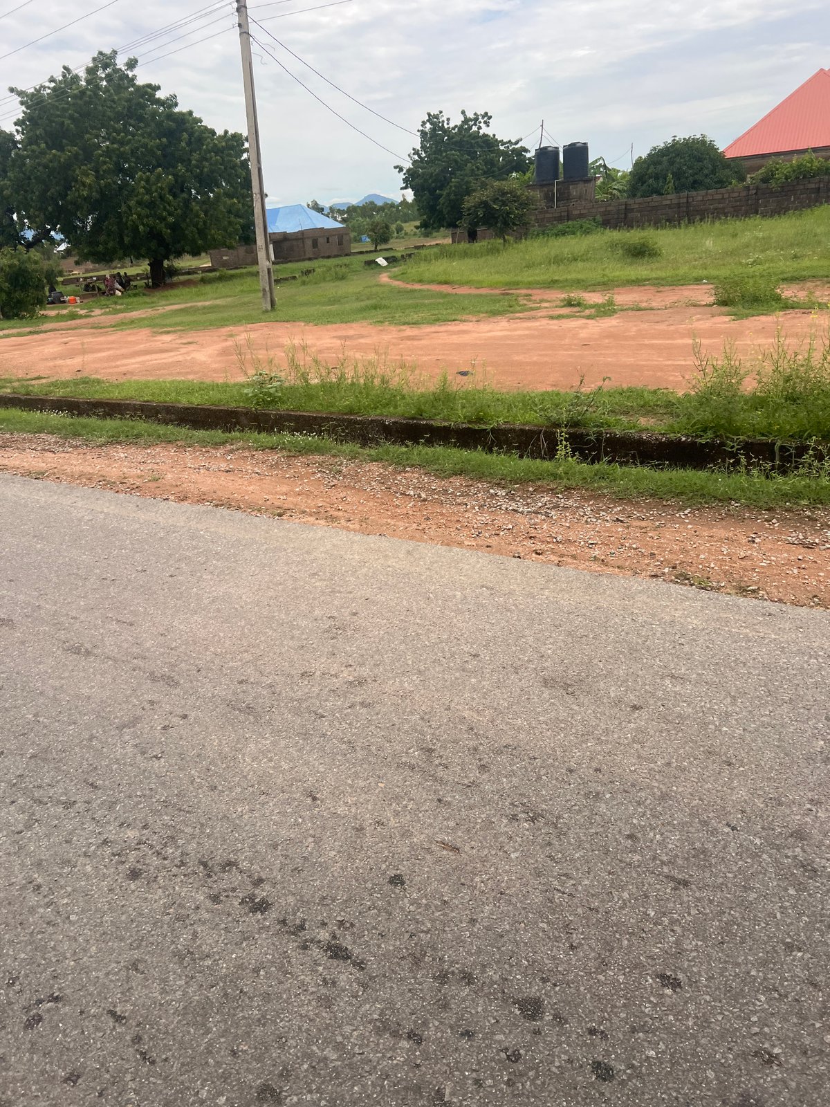 Kona Garu's roads, construction sites, and open land on an overcast afternoon
