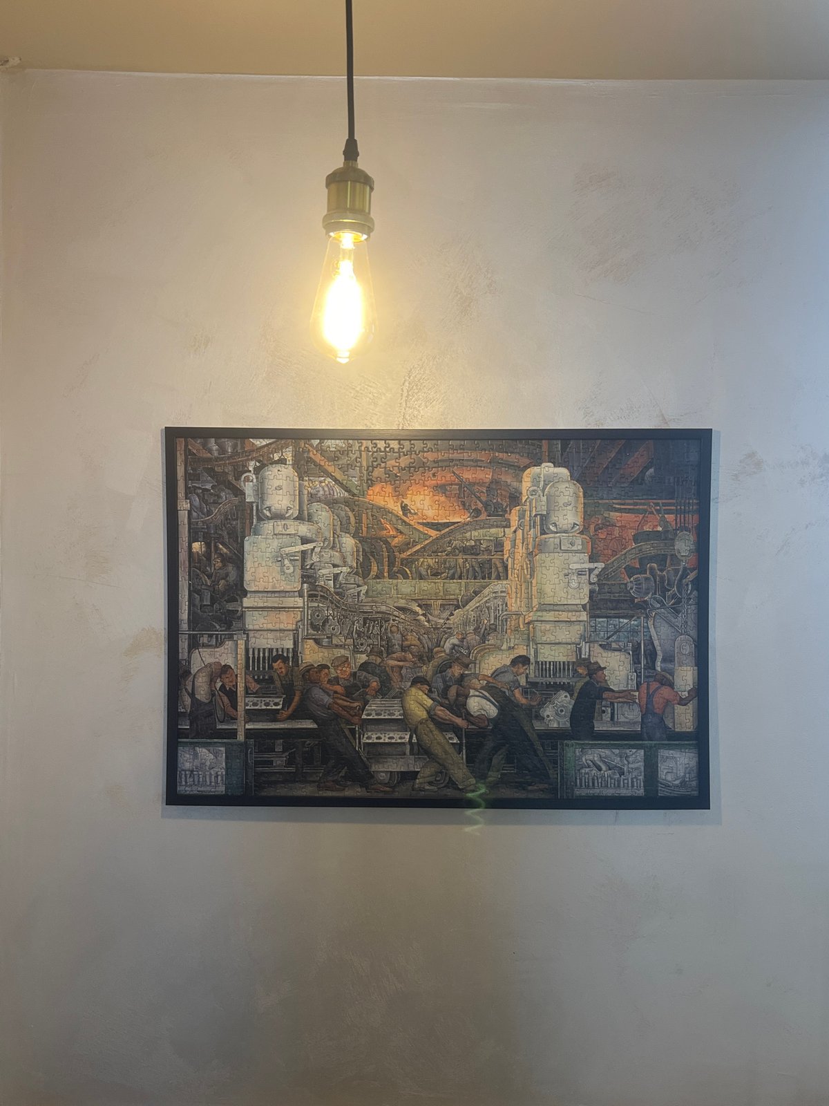 Interior scene with lightbulb and puzzle-piece machinery artwork documented