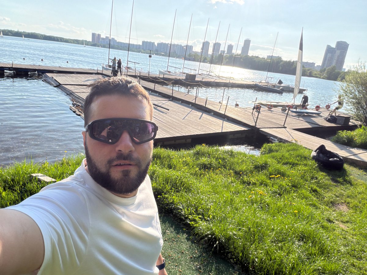 Man takes sunny selfie on wooden dock in Khimki