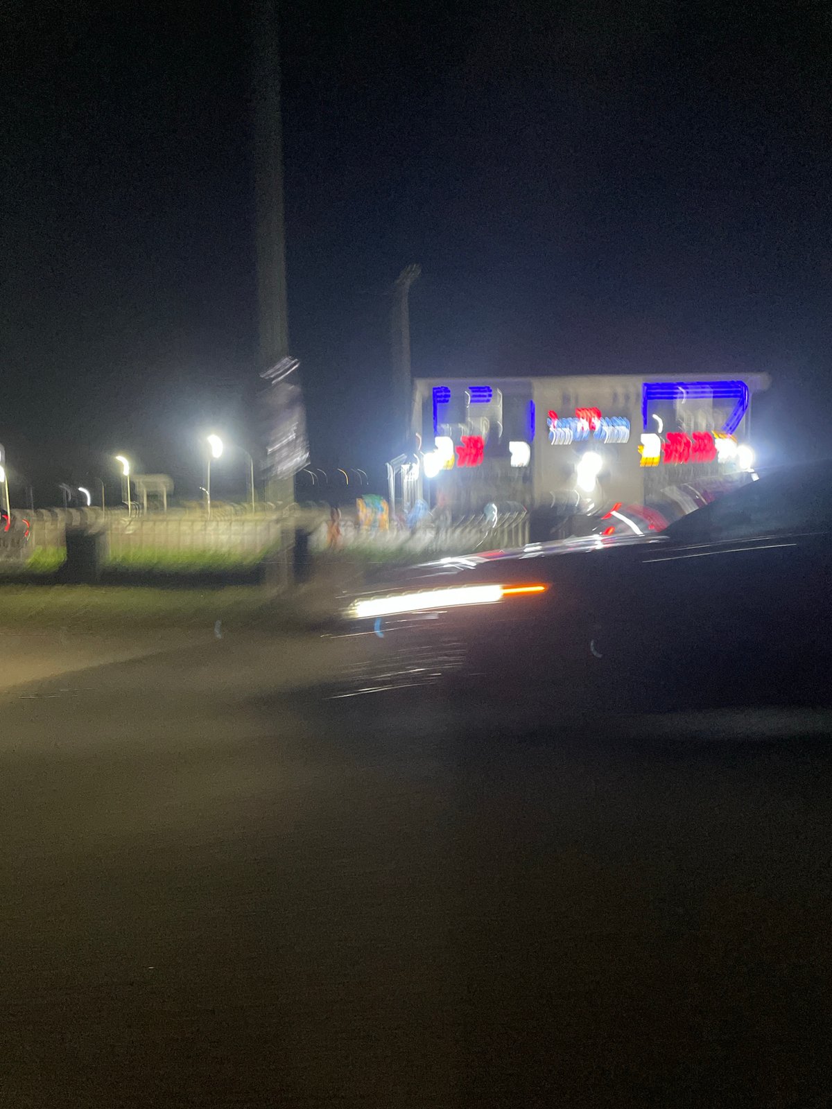 Motorcyclist rides through nighttime Abuja streets near Skyview Hotel