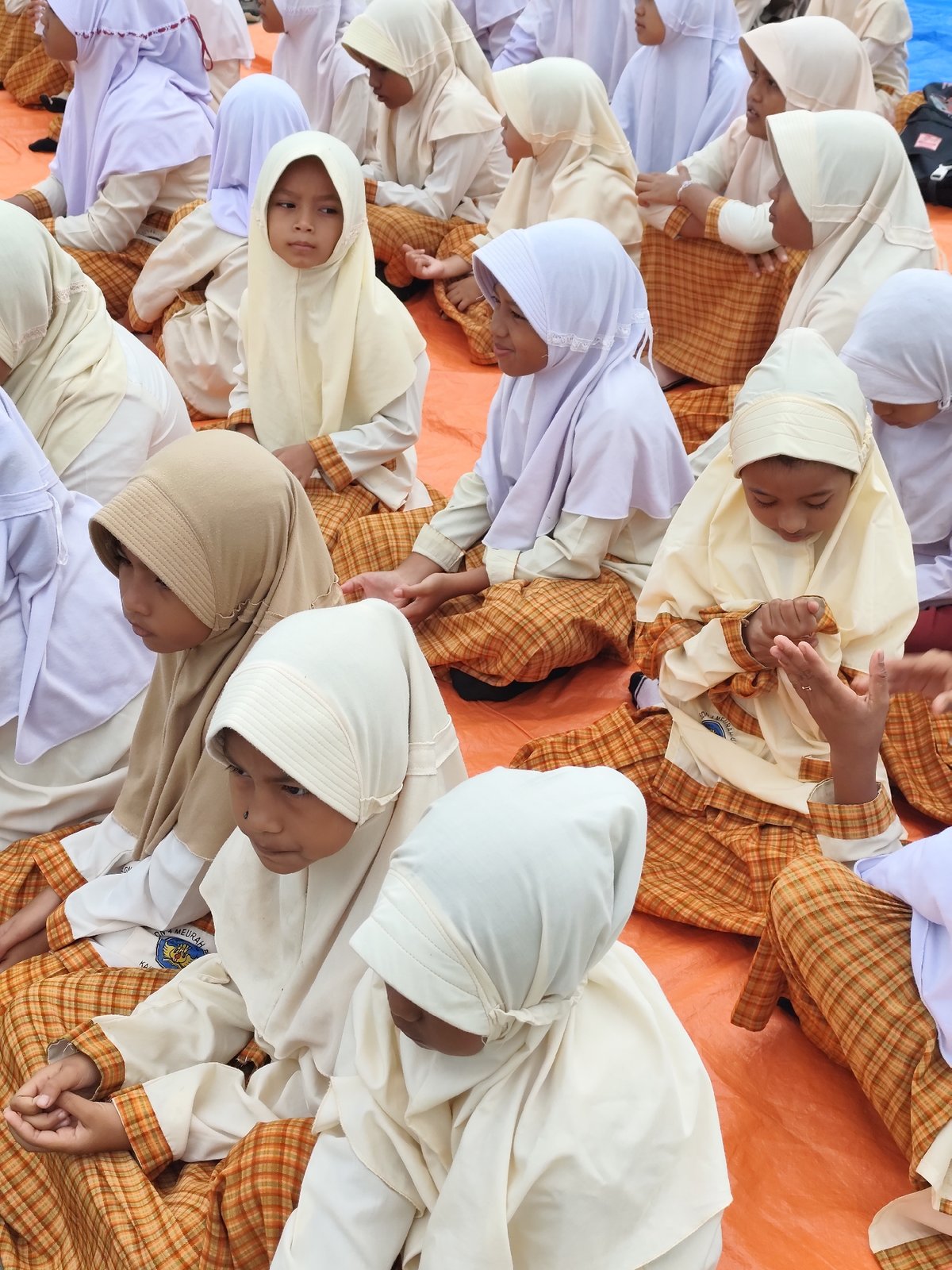 Children in traditional dress gather for an outdoor community event