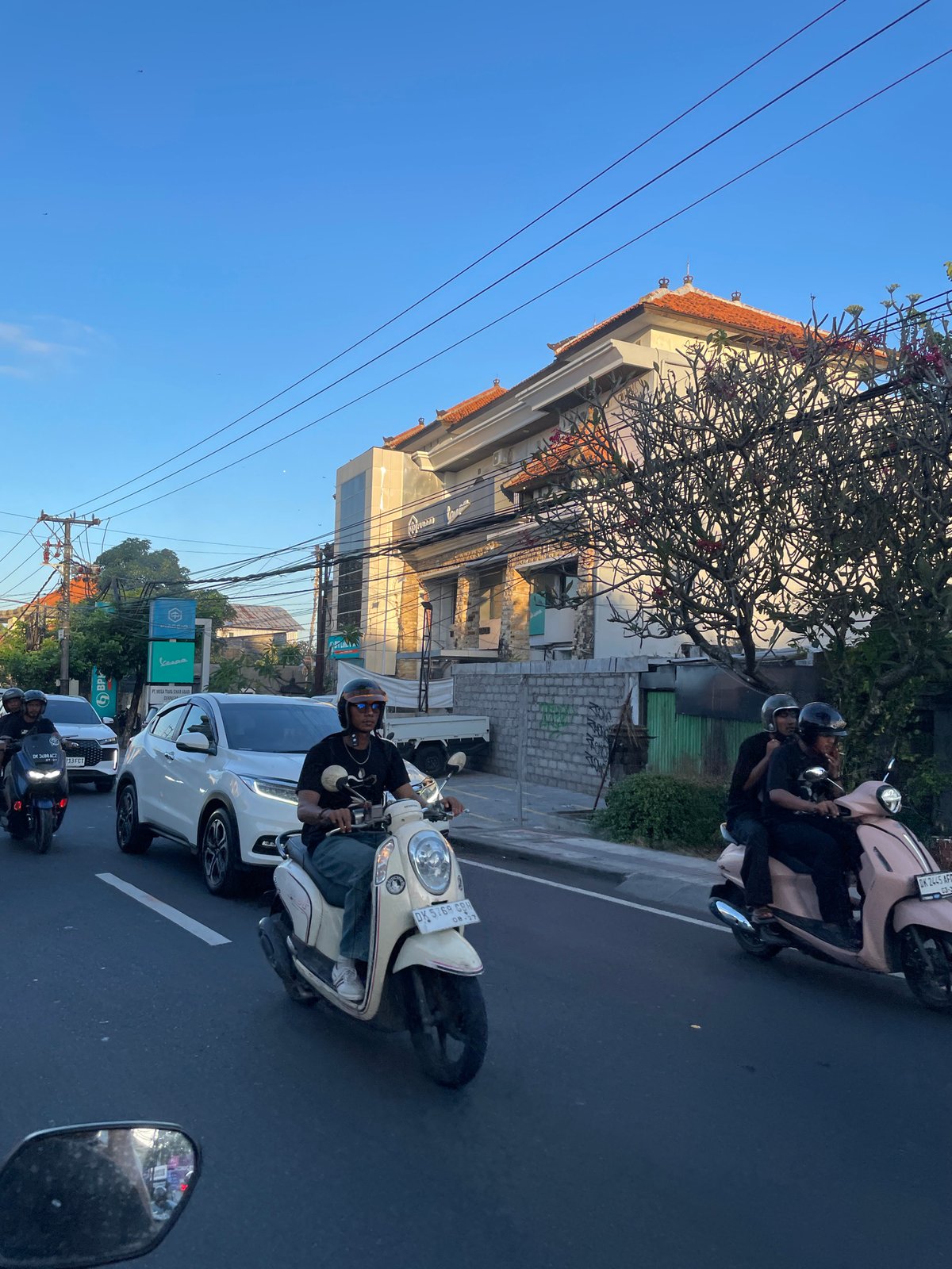 Denpasar street life: traffic, local shops, and city infrastructure