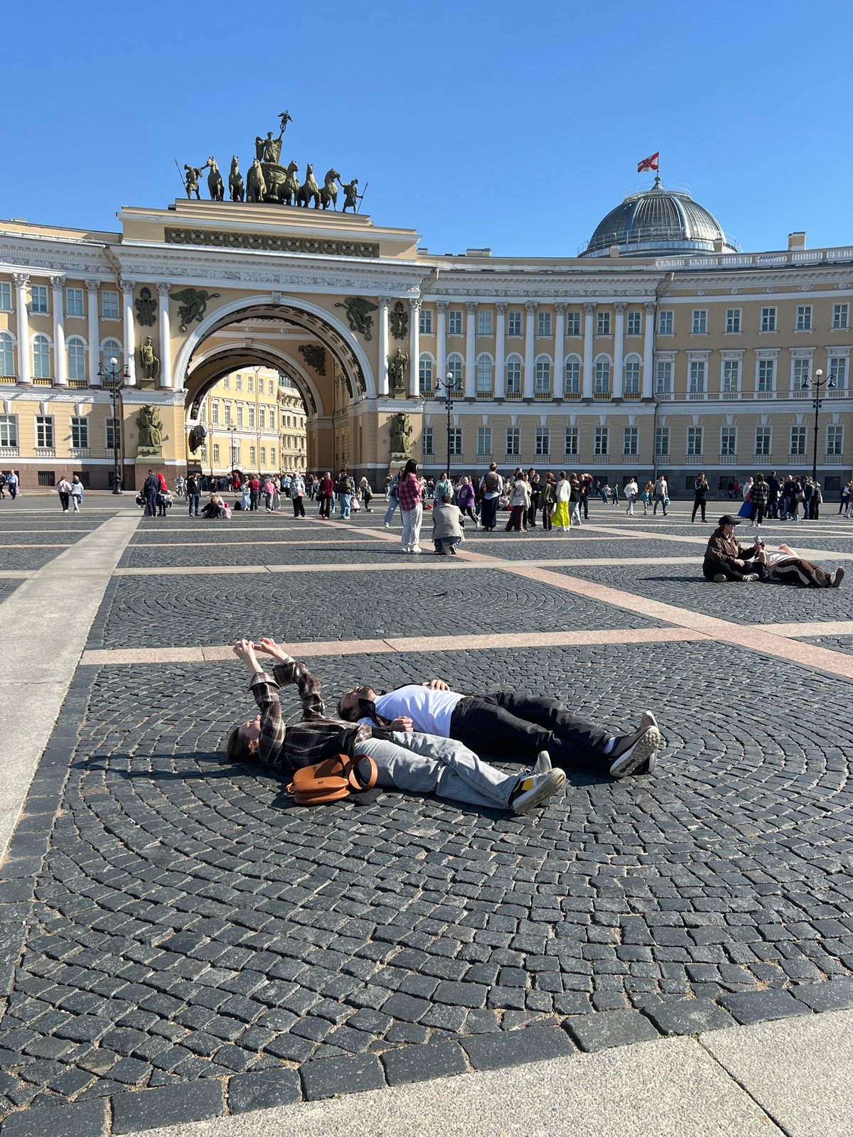 Two people observed on historic Saint Petersburg plaza