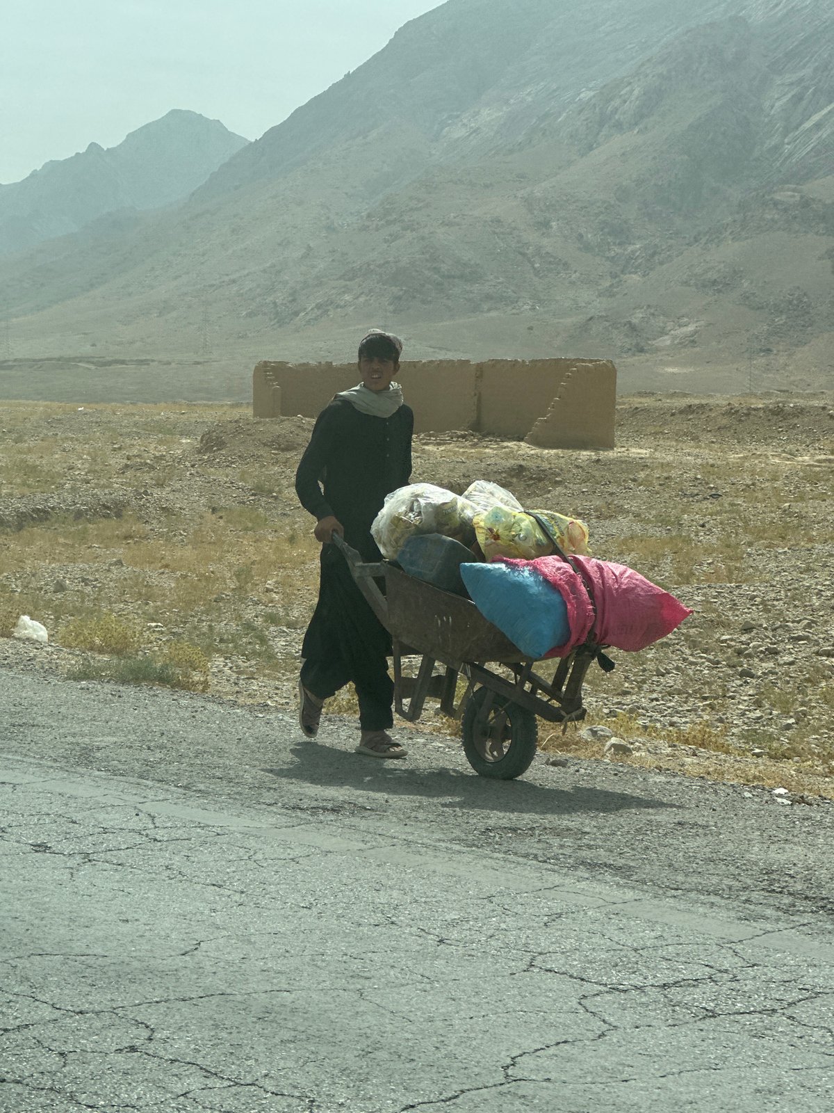 Wheelbarrow loaded with goods on a Khanai Baba road