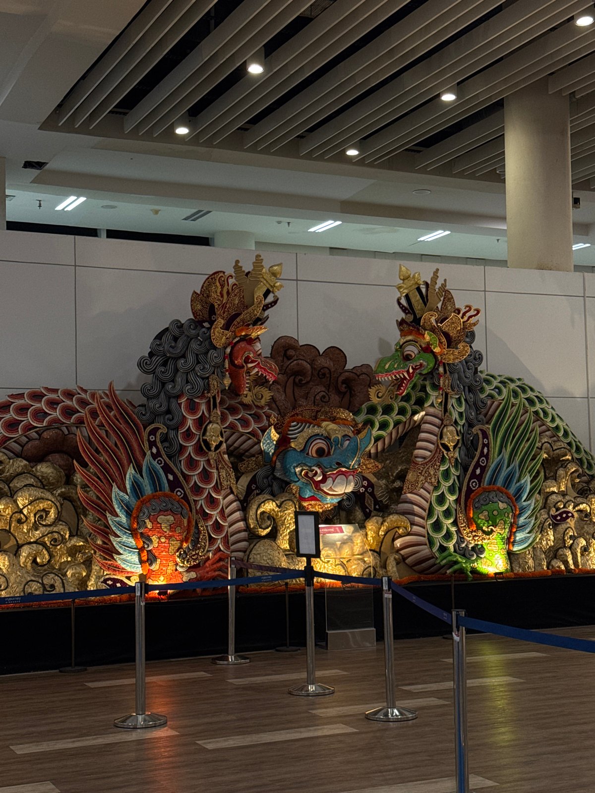 Father and daughter visit decorated public space with dragon artwork