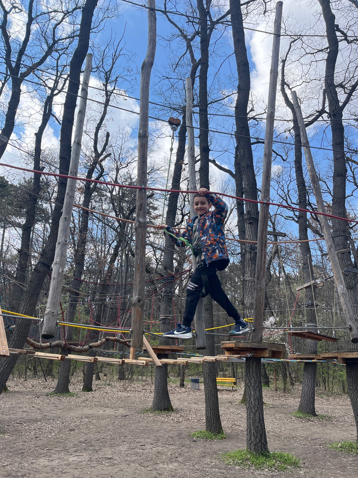 Child navigates treetop adventure course in Sofia park