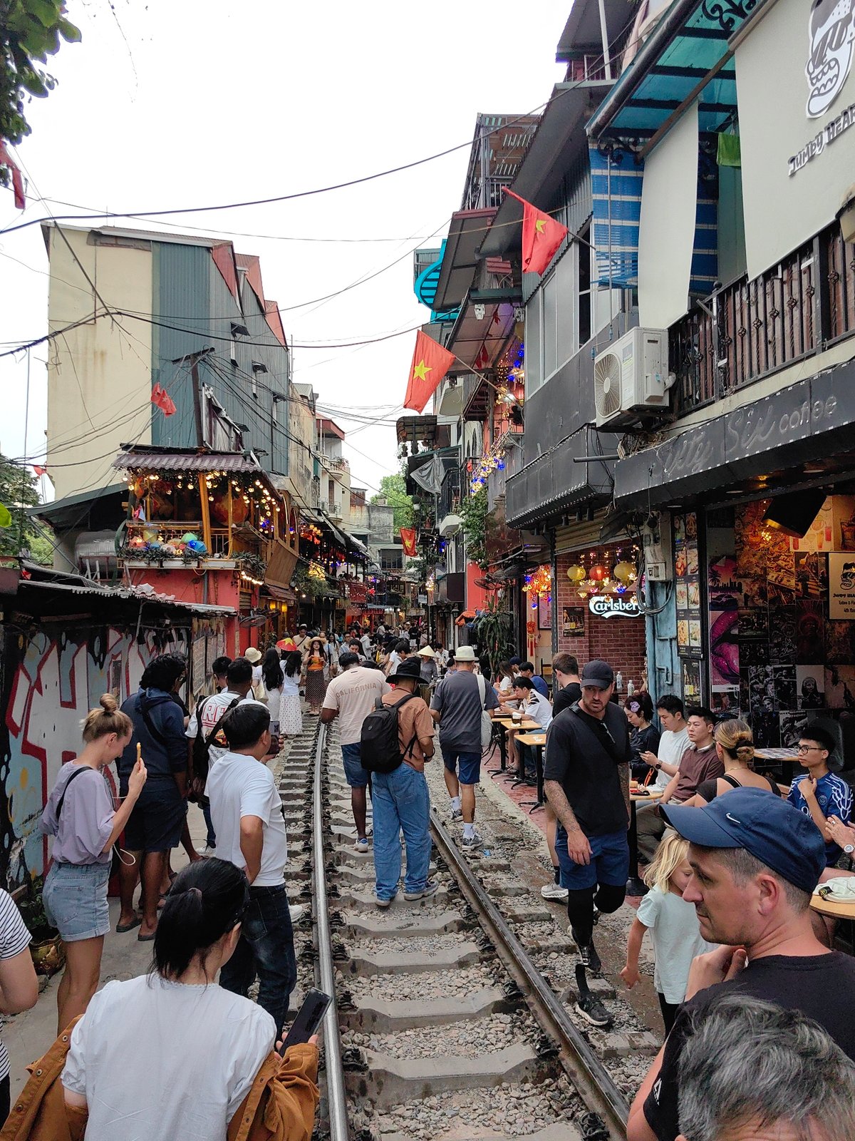 Tourists crowd Hanoi's Train Street during morning rush