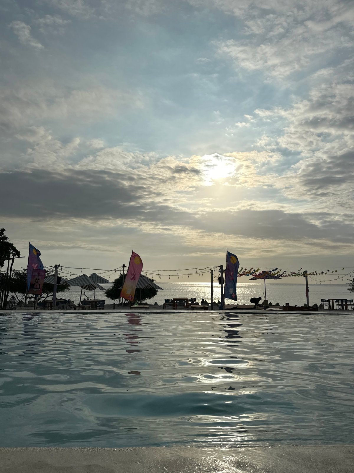Waterfront entertainment venue with pool and DJ booth observed in Indonesia