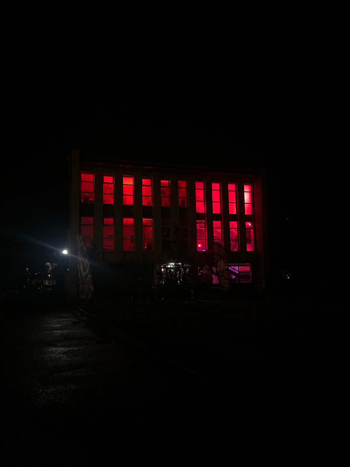 Building windows glow red-purple in nighttime Yerevan