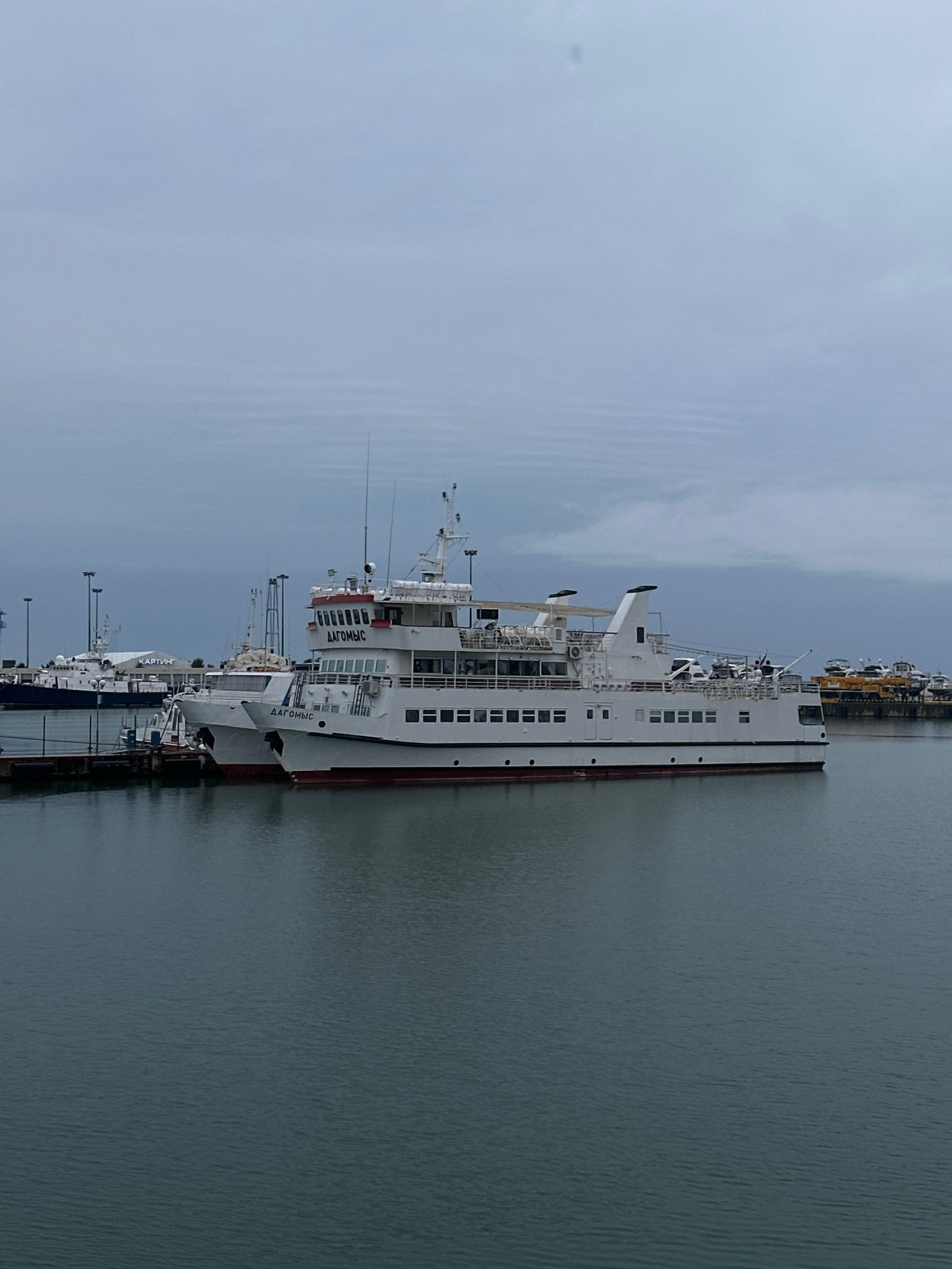 Routine harbor activity documented in Sochi during overcast afternoon