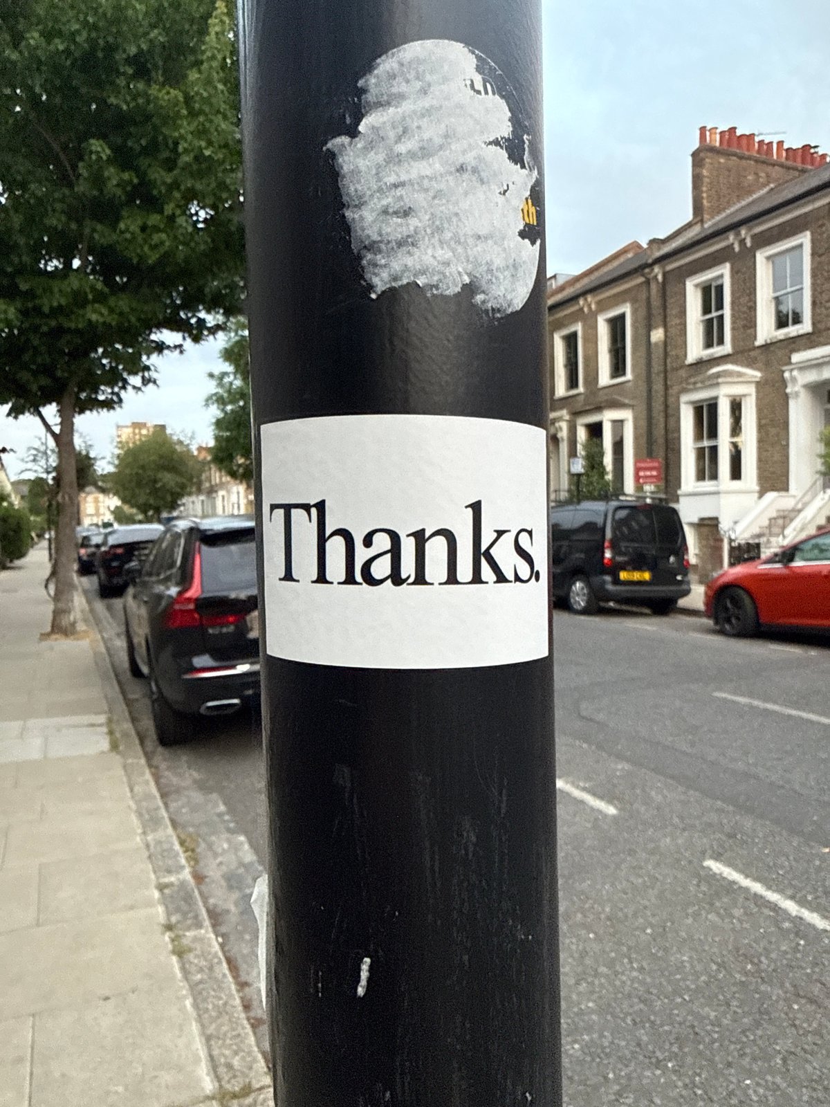 London evening captures: gratitude sticker and collared cat sighting