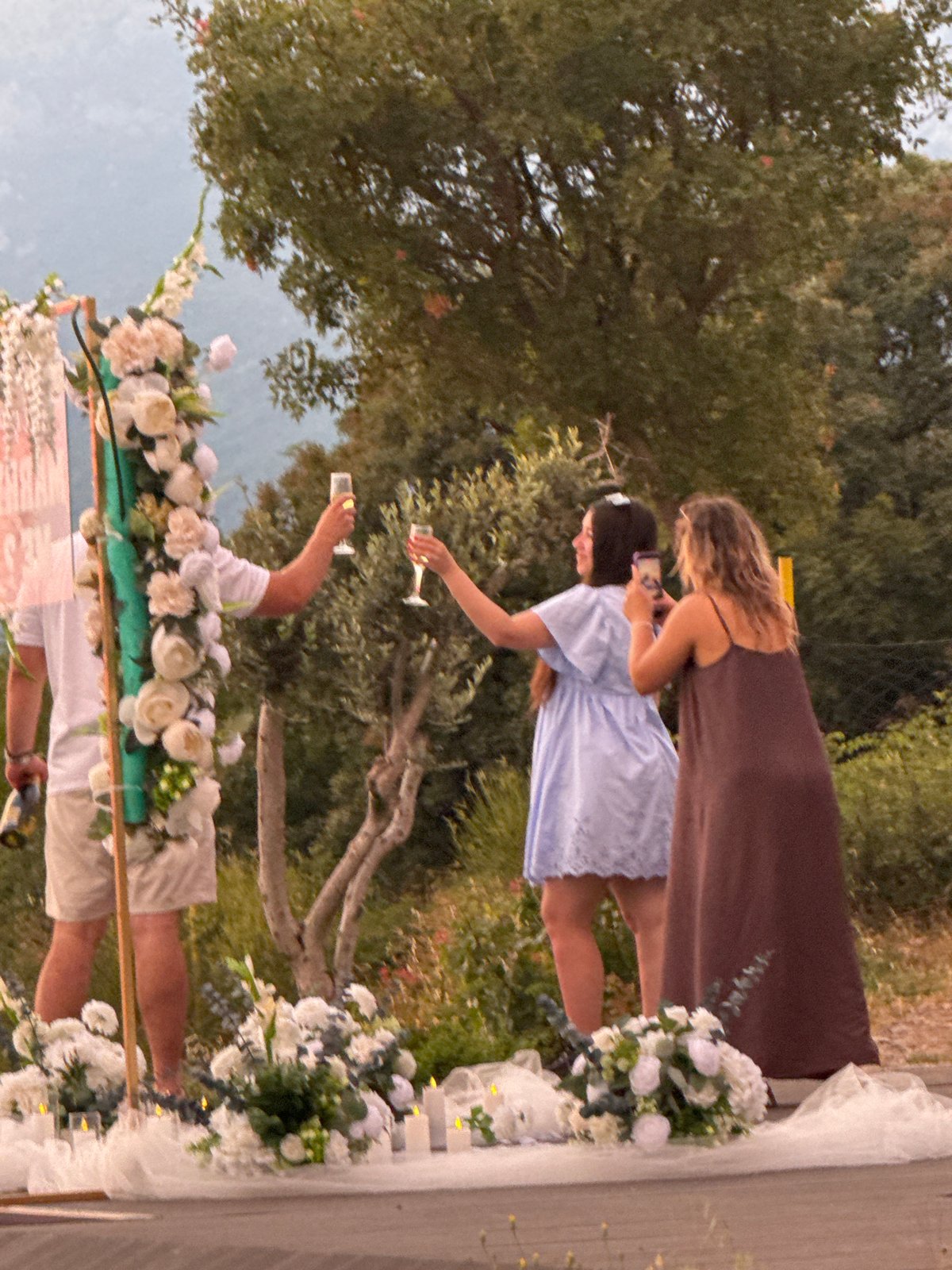 Sunset proposal at a flower arch on the Montenegrin coast