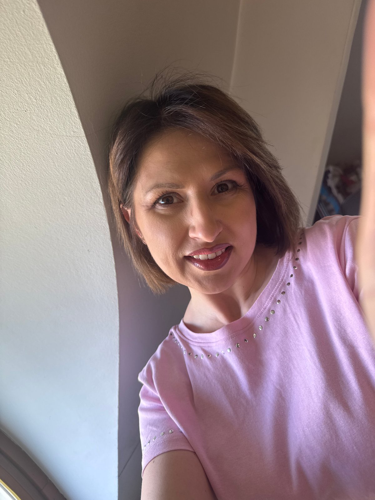 Person takes selfie in pink studded shirt in Sofia