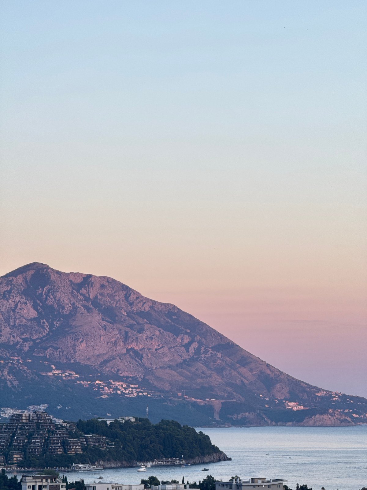 Budva at dusk: coastline, construction, and evening light