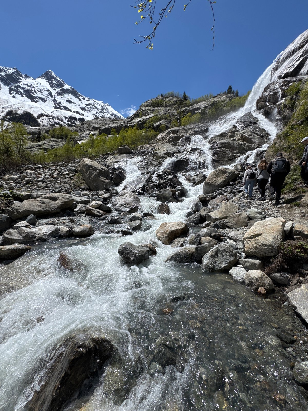Tourists visit mountain waterfall in Russian Caucasus region
