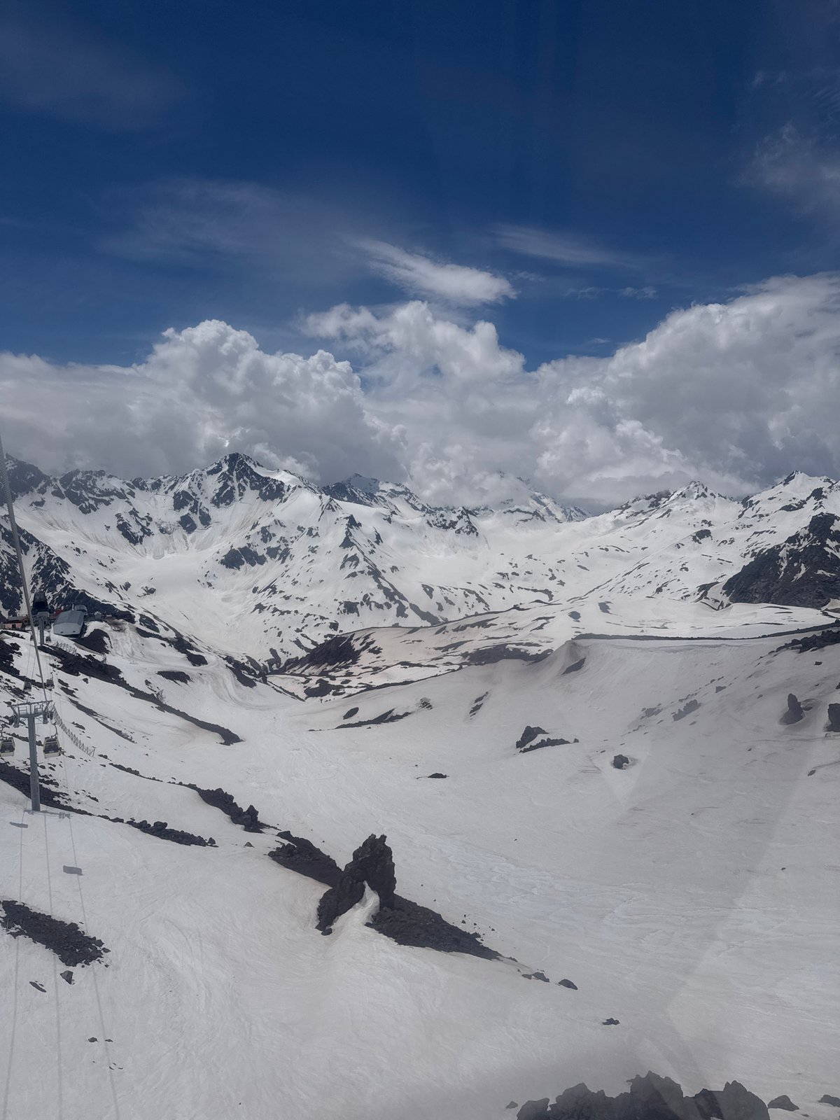 Snow-covered peaks and rocky ridges above Terskol, Russia