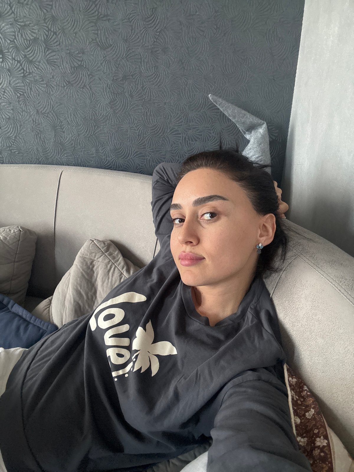 Woman rests on couch in Tbilisi home
