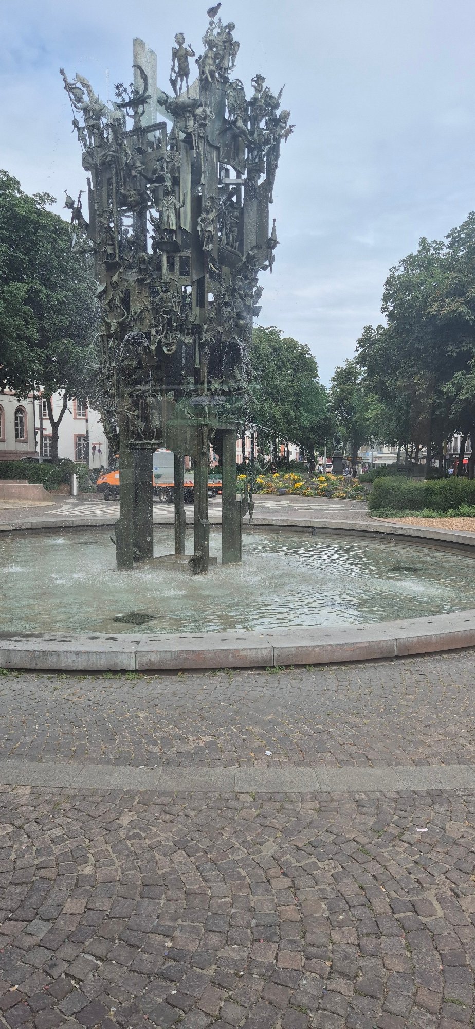Intricate bronze fountain spraying in central Mainz