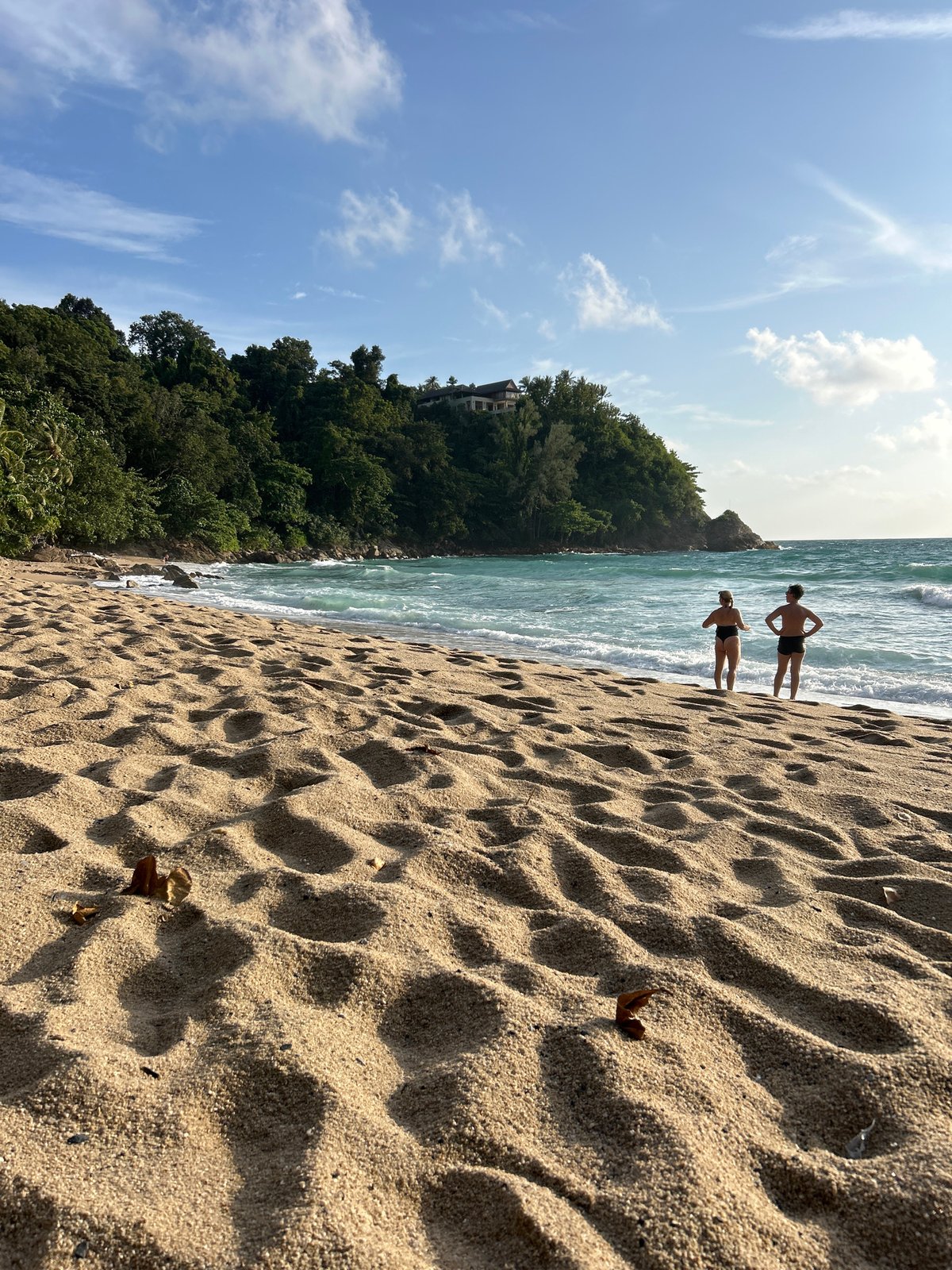Rocky Choeng Thale shoreline at golden hour, waves and all