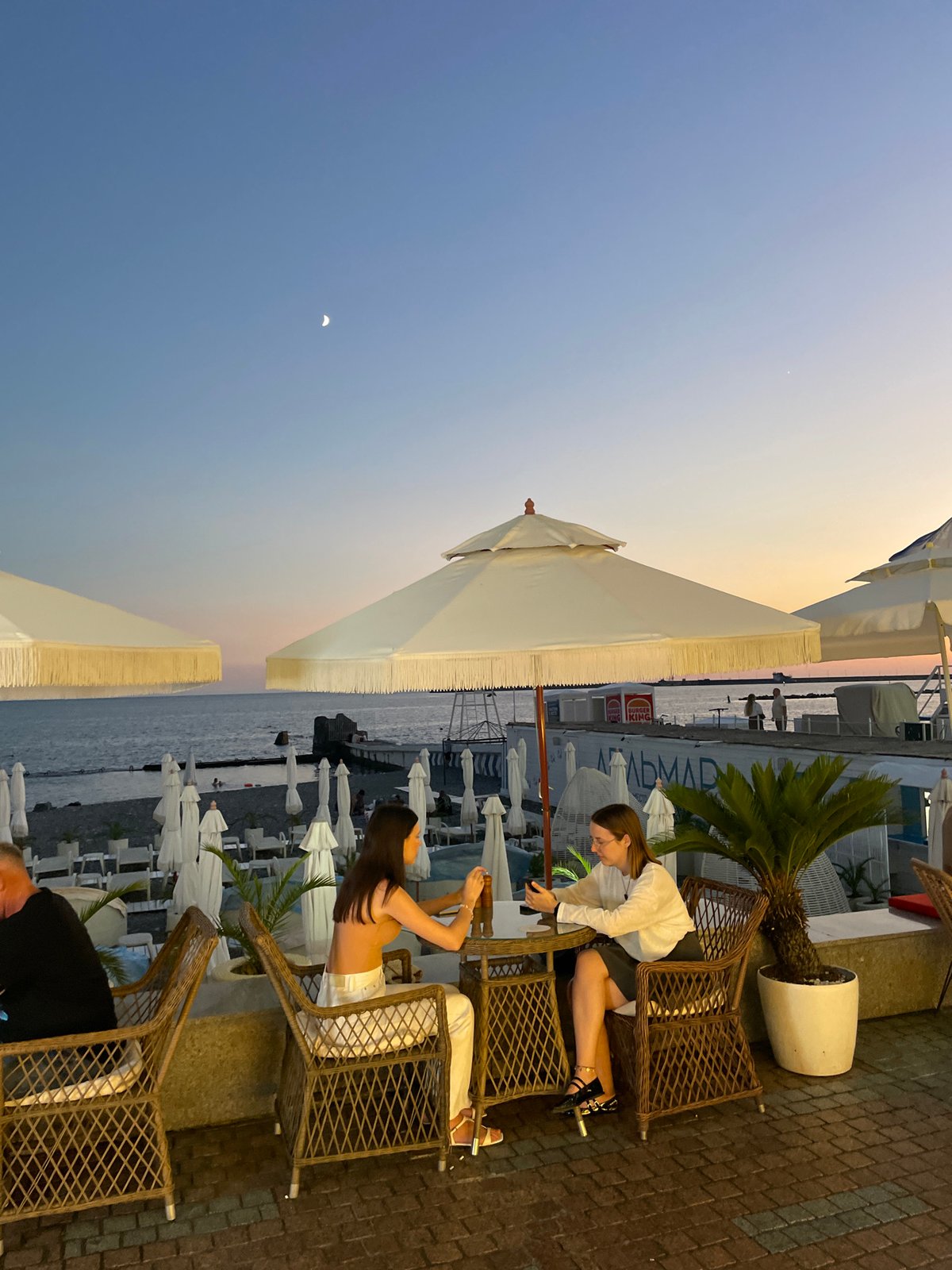 Sochi waterfront at sunset, promenade and beach bars buzzing