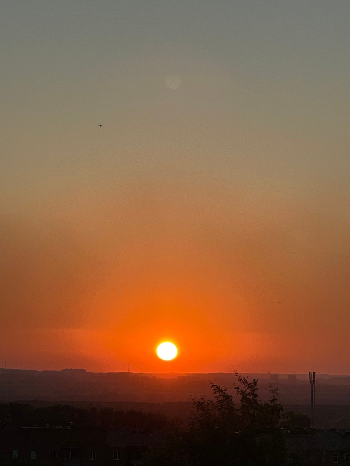 Backyard evening in Novokuznetsk under a fiery summer sunset