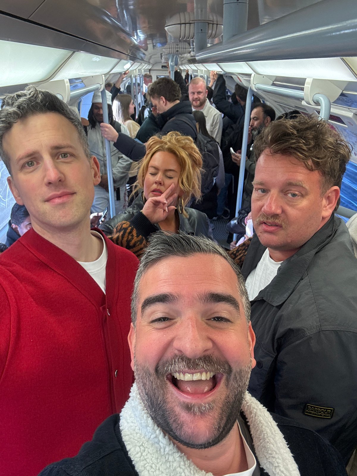 Commuters photographed on crowded London Underground train during evening rush
