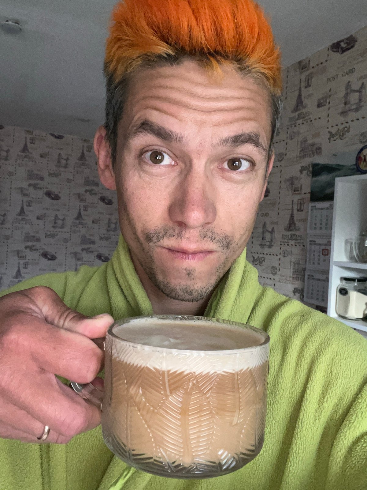Orange-haired man takes coffee selfie in Chaikovsky home