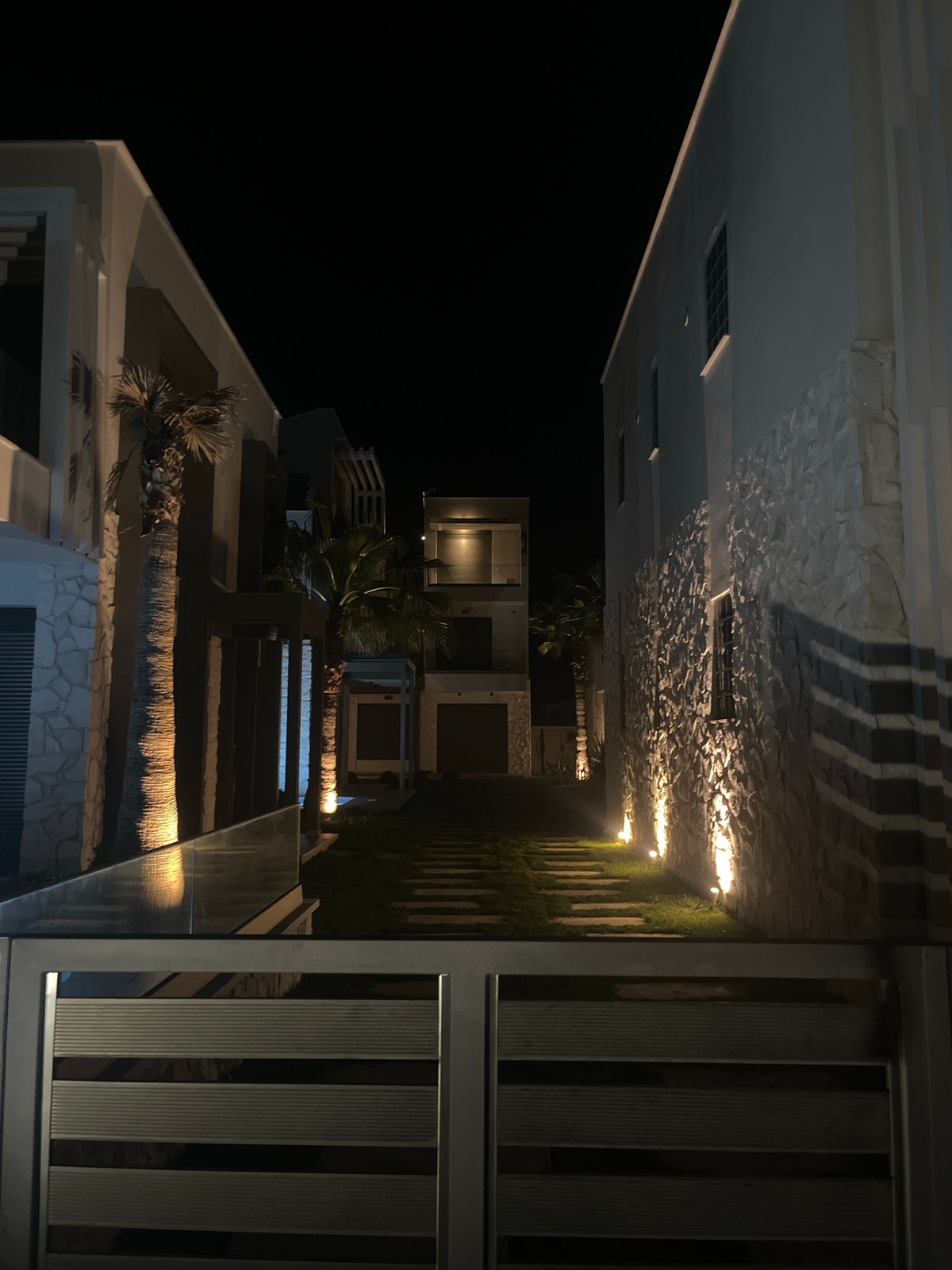 Modern beachside buildings documented at night in Ofrynio, Greece