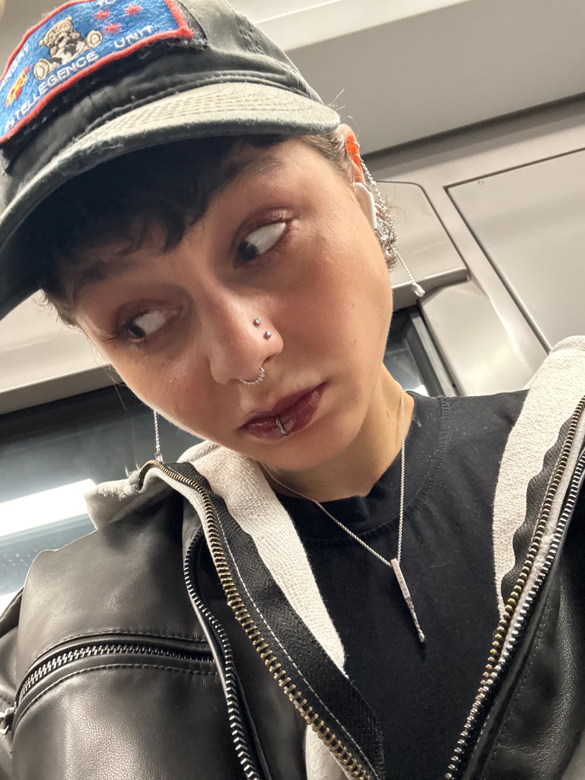 Person with facial piercings takes selfie in Moscow