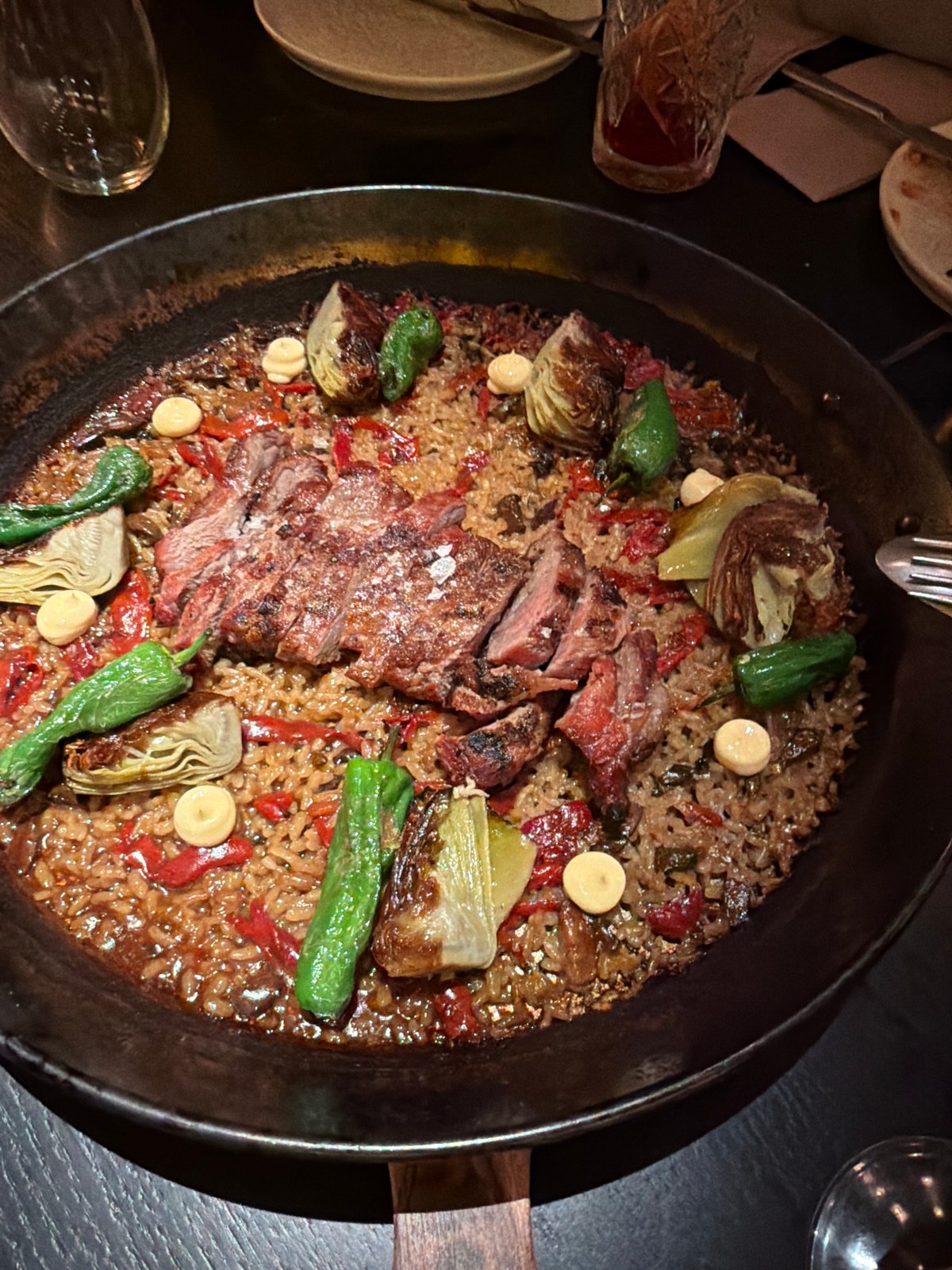 Diners photograph paella and sandwich at San Sebastián restaurant