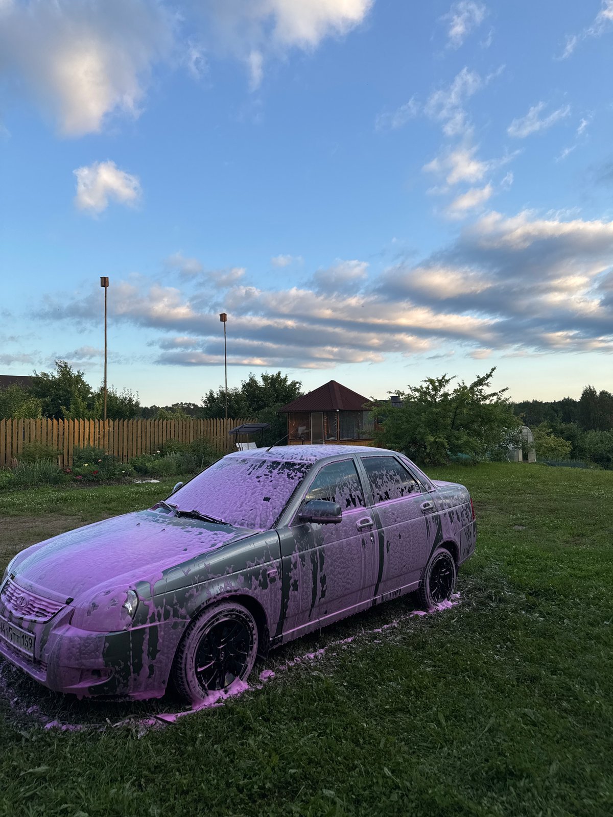 Backyard foam car wash in a rural Russian garden