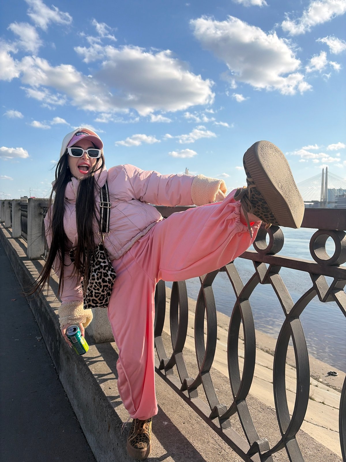 Tourists pose for photos along Saint Petersburg's Neva River embankment