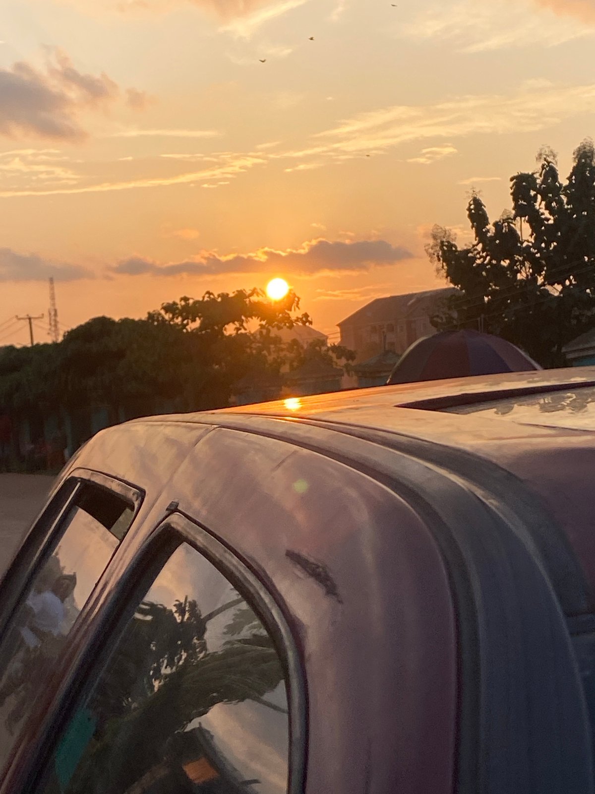 Orange sunset through clouds over Abakaliki, Nigeria