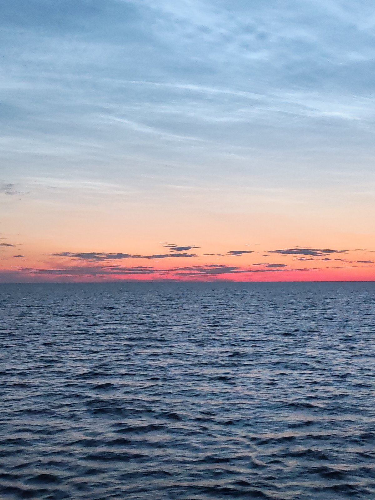 Twilight over a Russian coastal pier, sky bleeding pink