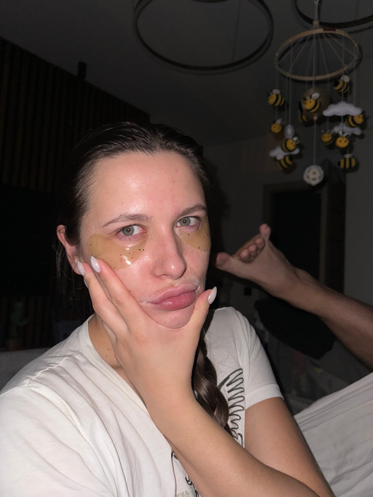Woman applies eye patches indoors in Akulovo, Russia