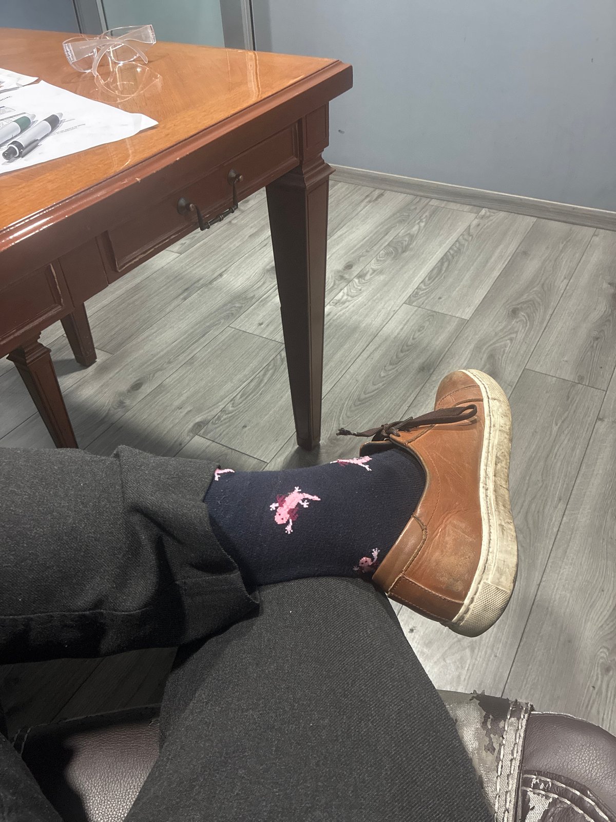 Person with flamingo socks sits by desk in Mexico