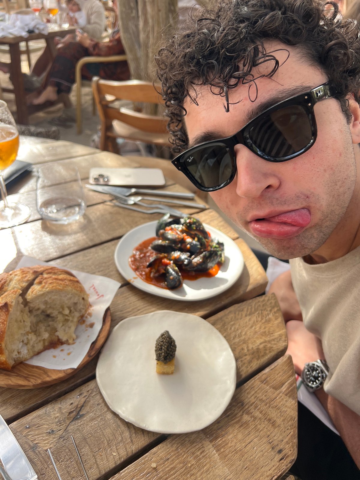 Man takes playful selfie at Spanish restaurant