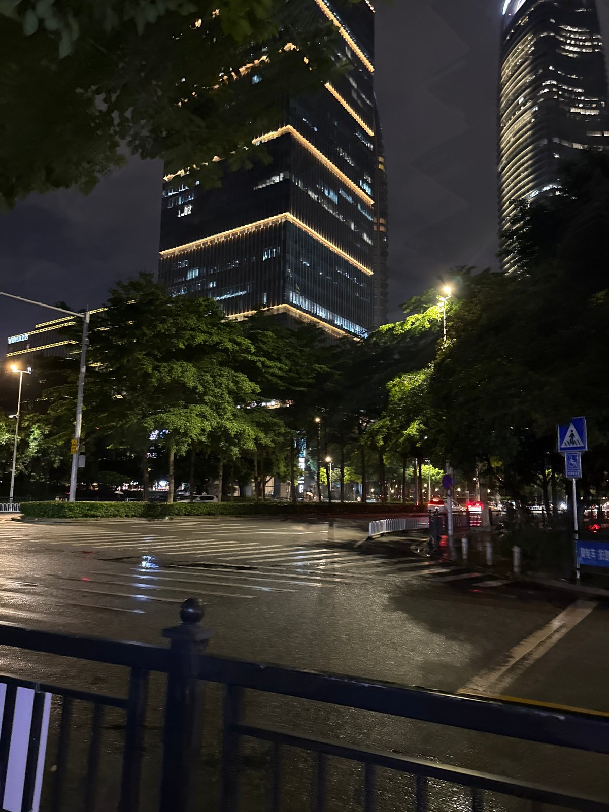 Rainy night on the neon-lit streets of Haizhu District