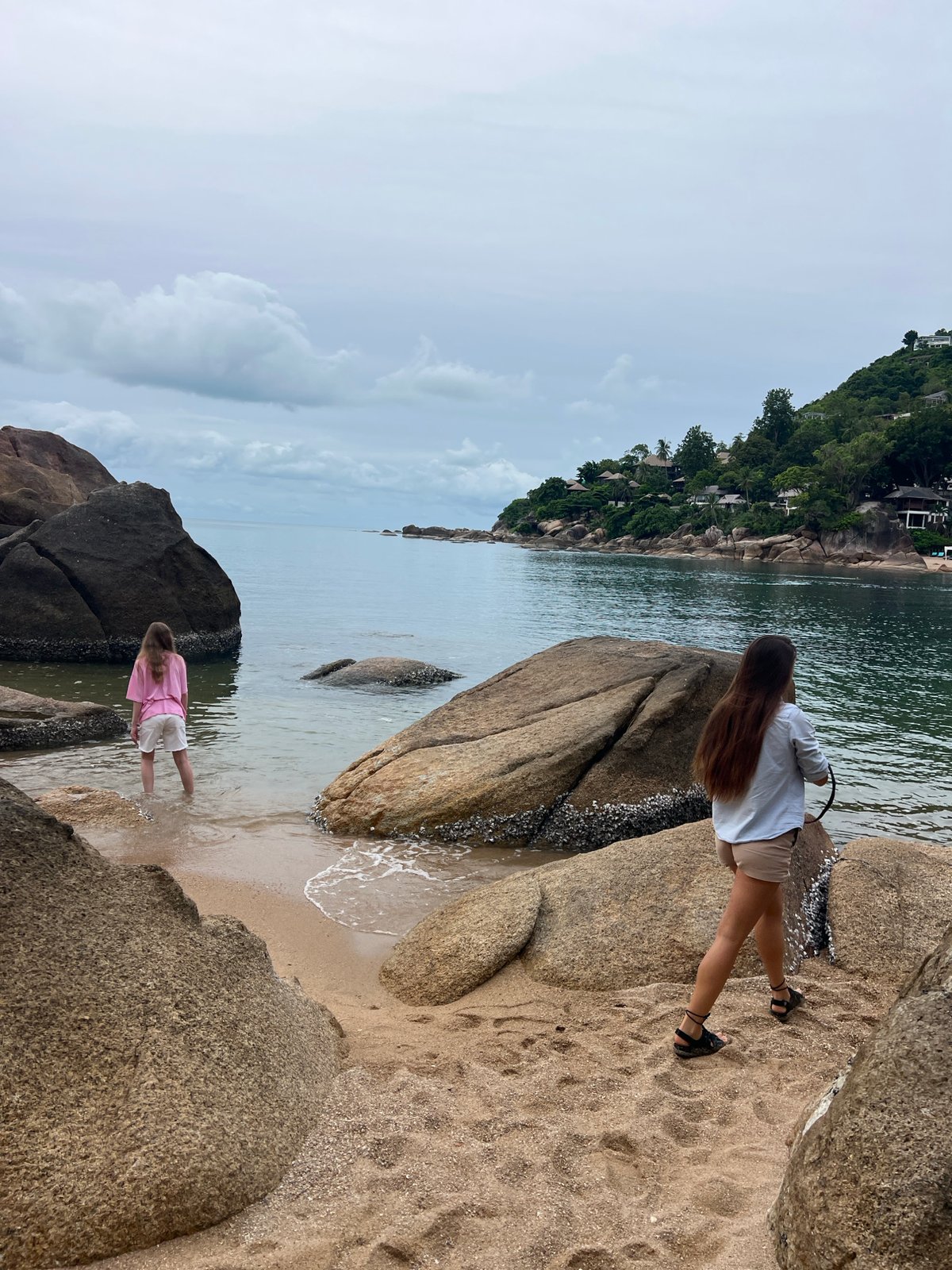 Two women spend quiet moments at Thai beach