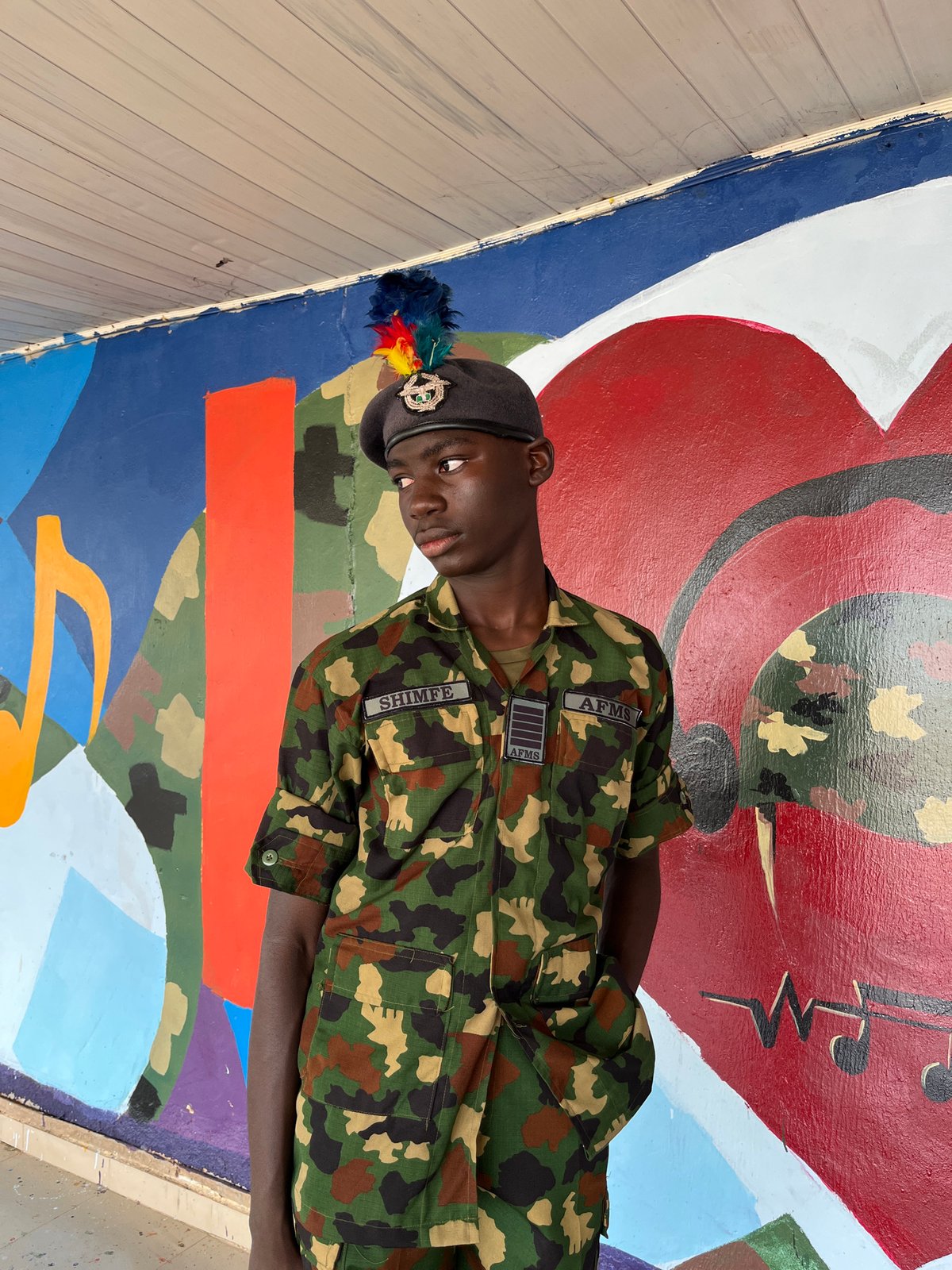 Group portraits in front of a vibrant mural in Bar Jirgi Summa