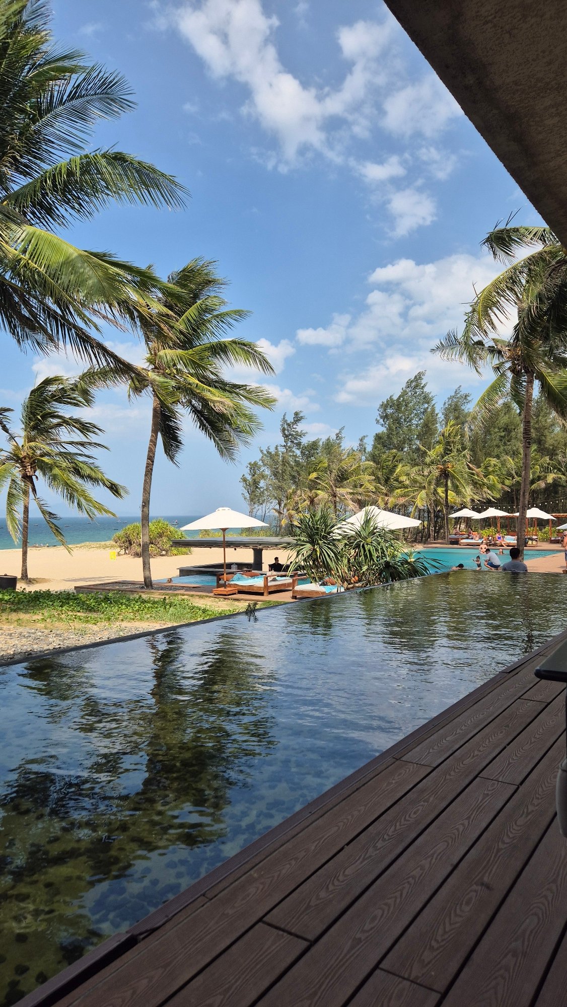 Beachfront resort pool on a sunny day in Hoi An