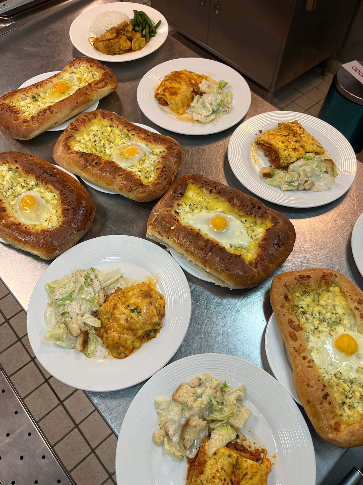Prepared dishes arranged on commercial kitchen counter
