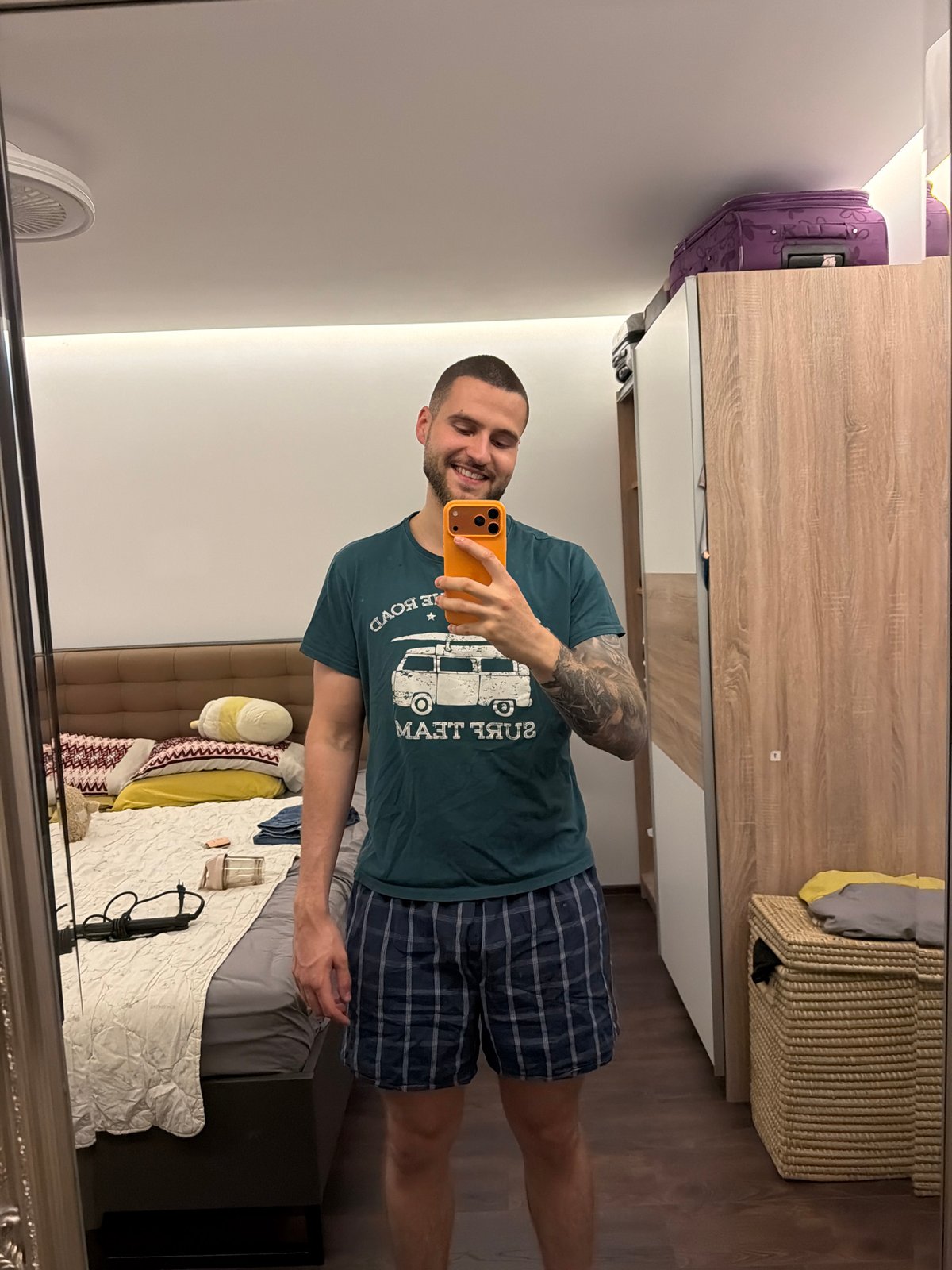 Couple takes multiple mirror selfies in Sofia bedroom