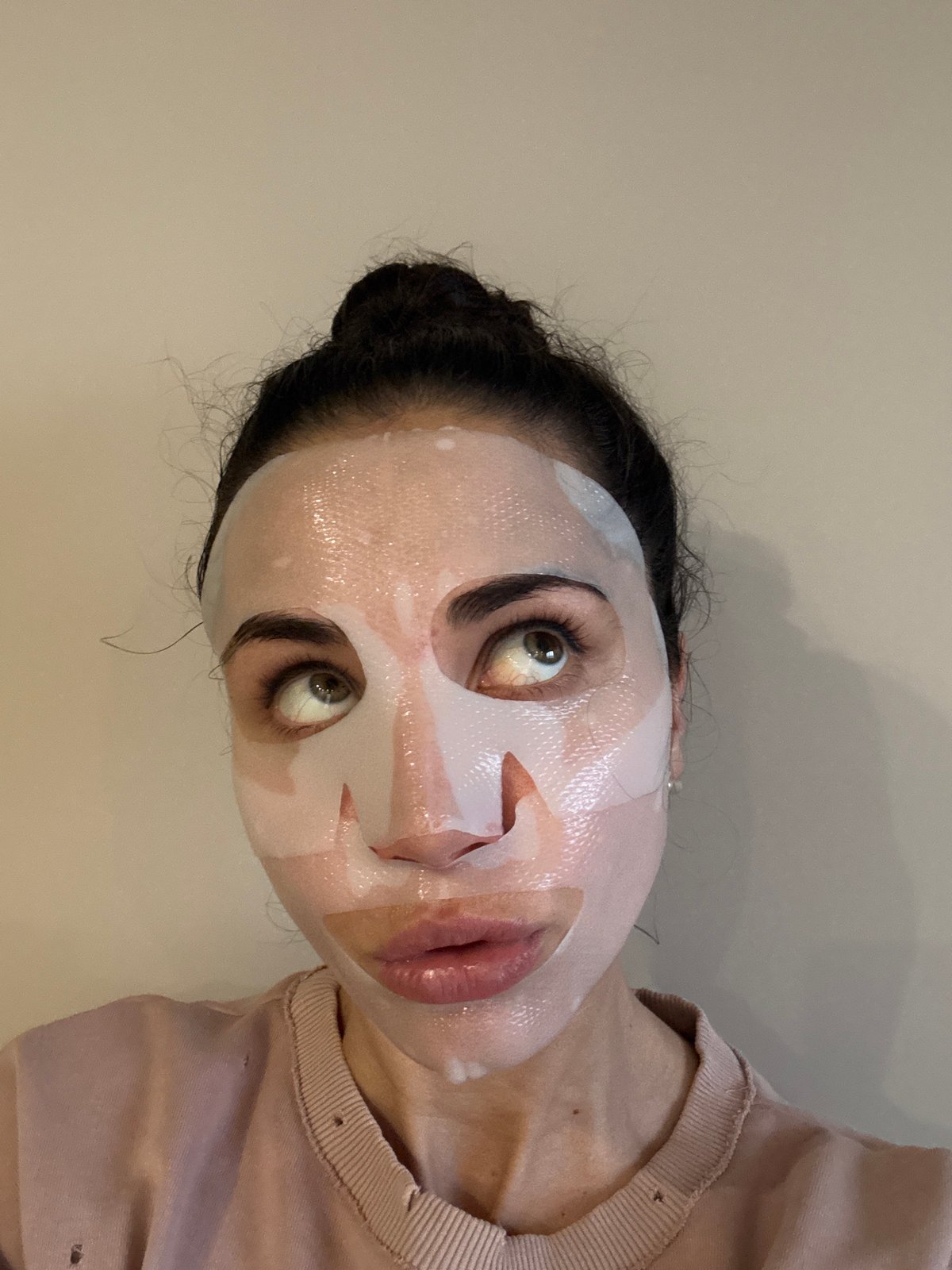 Woman applies face mask in Moscow indoor setting