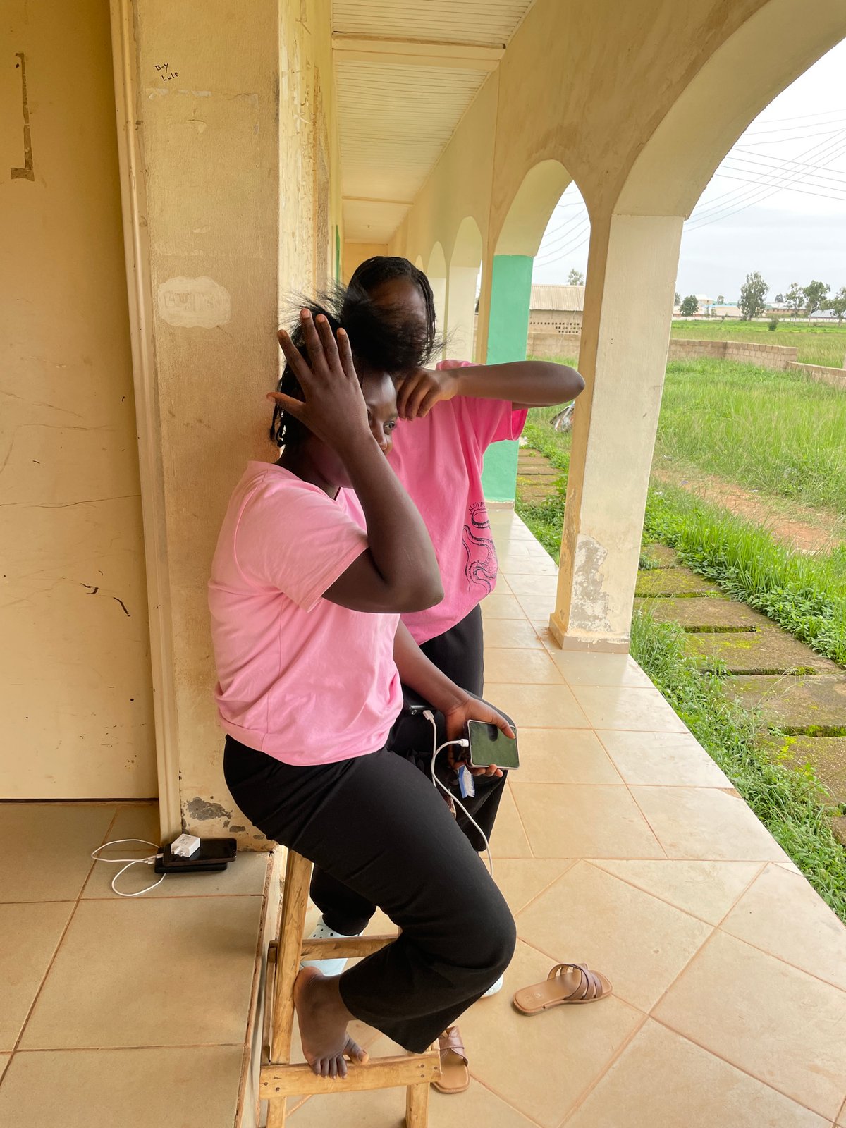 Outdoor hair braiding session in Durimi, Nigeria