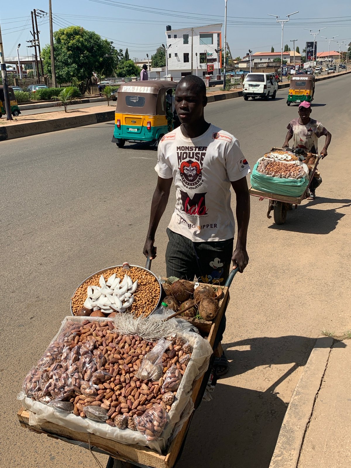 Daily street life documented across Jos, Nigeria during sunny morning