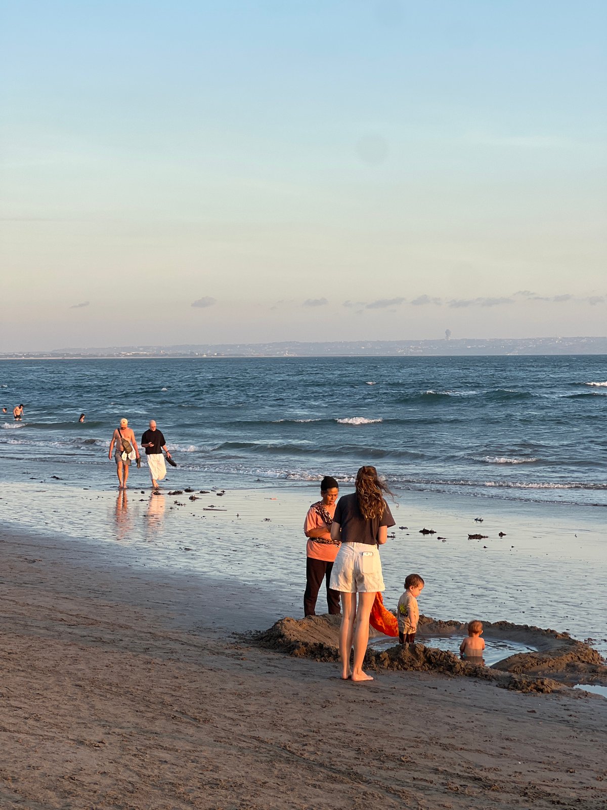 Golden hour crowd scene on a North Kuta beach