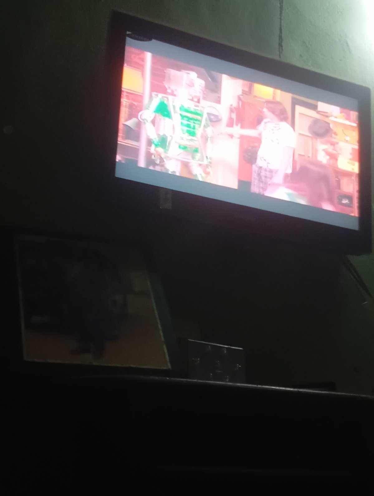 Television displays robot and pajama-clad person scene