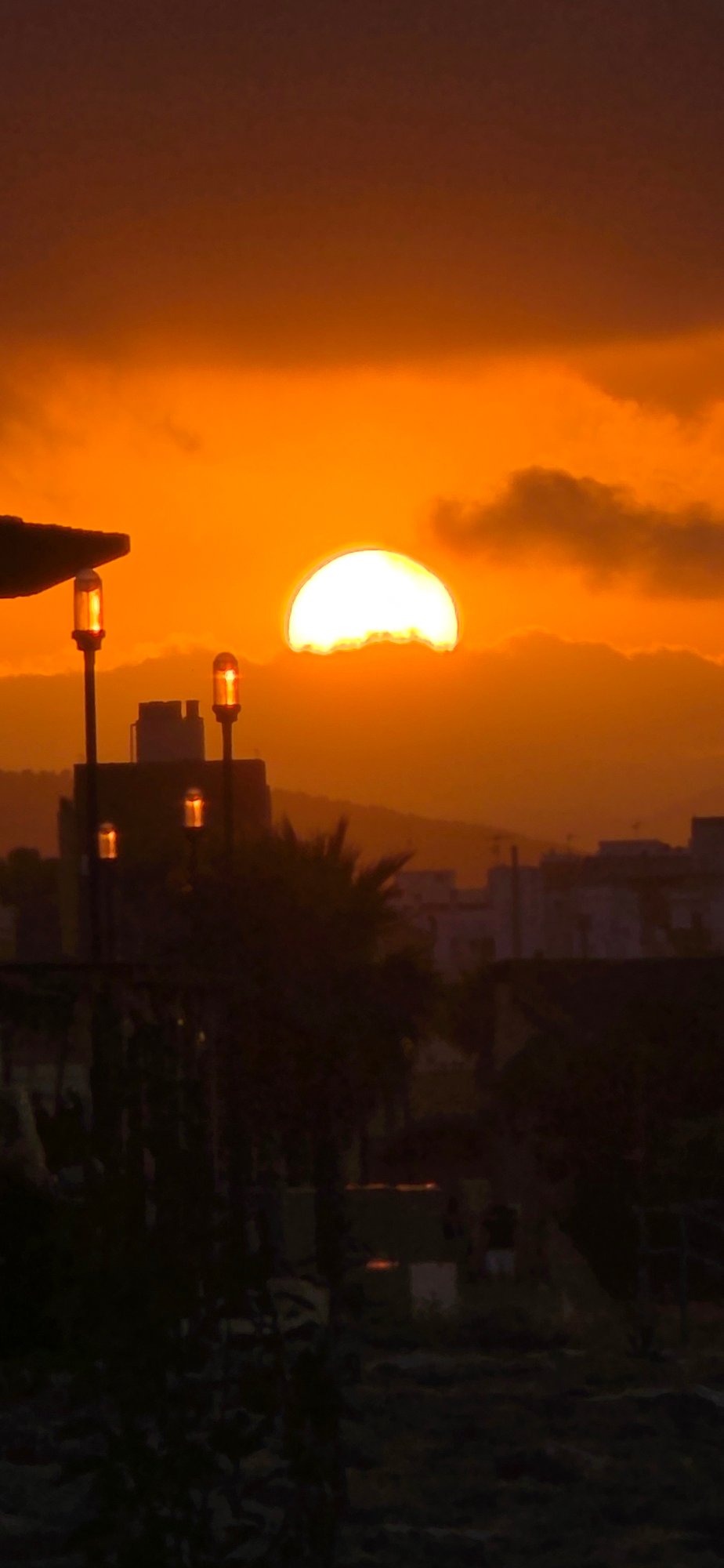 Evening beach activities documented during dramatic sunset in Sagunto